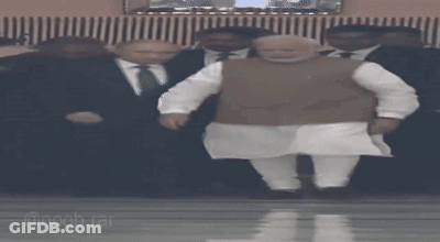 Man In Suit Standing Next To Man In White Shirt GIF