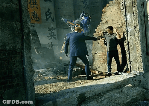 Man In Suit Standing Next To Robot With Chinese Writing GIF