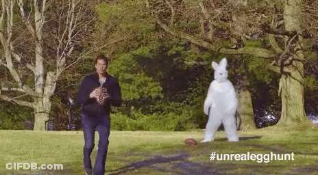 Man In Suit Standing Next To White Bunny GIF