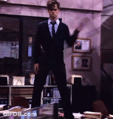 Man In Suit Standing On Desk GIF