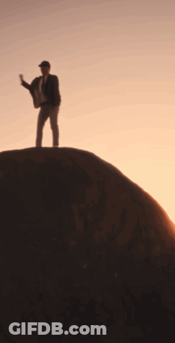 Man In Suit Standing On Hill GIF