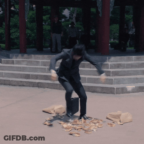 Man In Suit Standing On Pile Of Food GIF