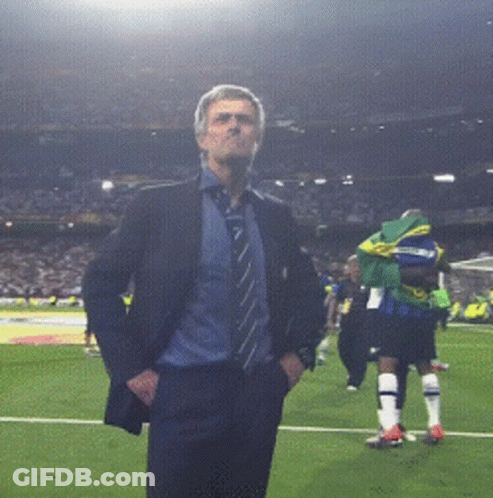 Man In Suit Standing On Soccer Field GIF