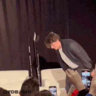 Man In Suit Standing On Stage GIF