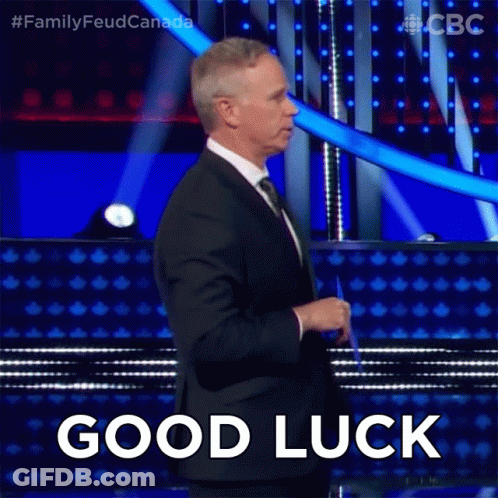 Man In Suit Standing On Stage With Good Luck GIF