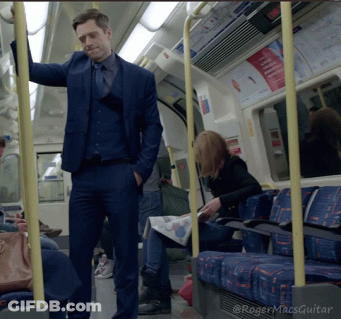 Man In Suit Standing On Train GIF