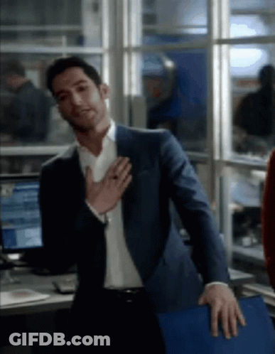Man In Suit Standing With Hands On Chest GIF