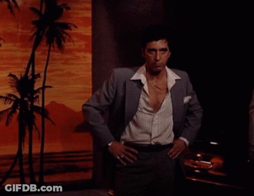Man In Suit Standing With Hands On Hips GIF