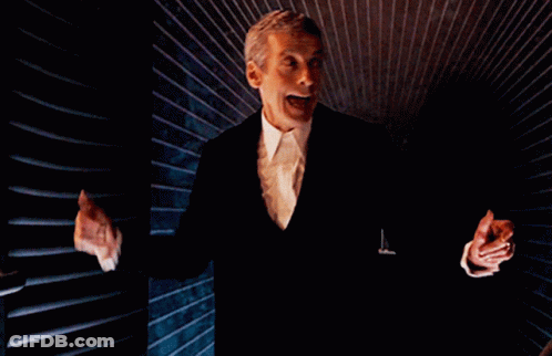 Man In Suit Standing With Hands Outstretched GIF