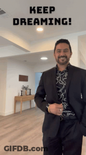 Man In Suit Standing With Keep Dreaming GIF