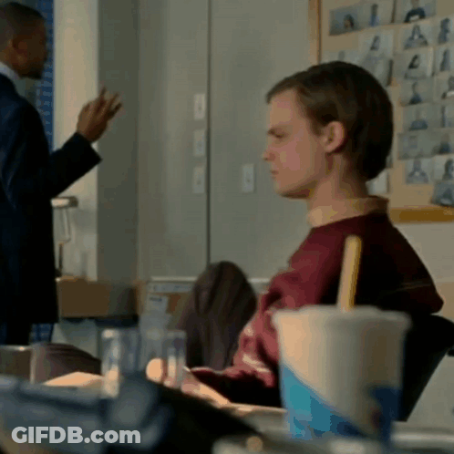 Man In Suit Stands Next To Man In Red Sweater GIF
