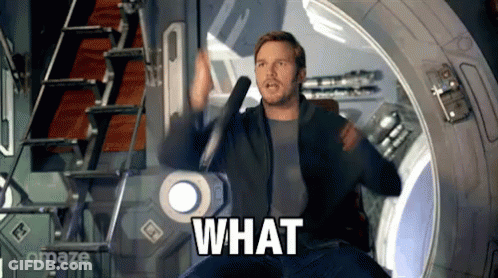 Man In Suit Surprised At Table GIF