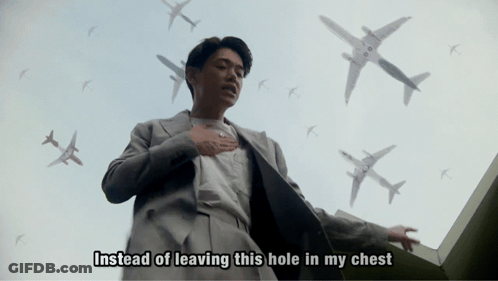 Man In Suit Surrounded By Airplanes Saying Instead Of Leaving This Hole In My Chest GIF