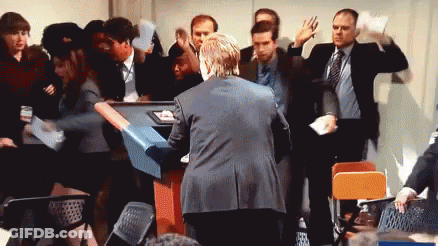 Man In Suit Surrounded By Crowd GIF
