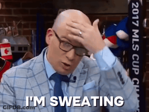 Man In Suit Sweating Holding Head GIF