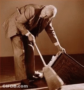 Man In Suit Sweeping Floor GIF