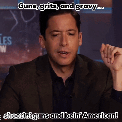 Man In Suit Talking About Guns Grits And Gravy GIF