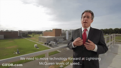 Man In Suit Talking About Lightning McQueen Speed GIF