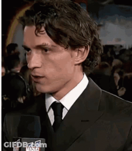 Man In Suit Talking Into Marvel Microphone GIF