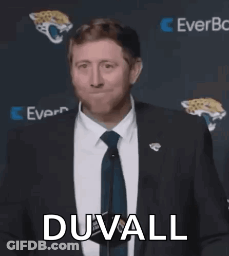 Man In Suit Talking Into Microphone GIF