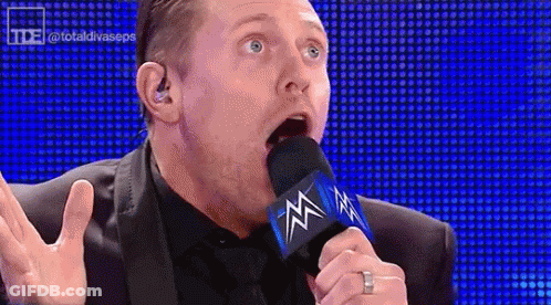 Man In Suit Talking Into Microphone GIF