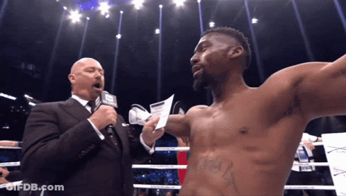 Man In Suit Talking Into Microphone GIF