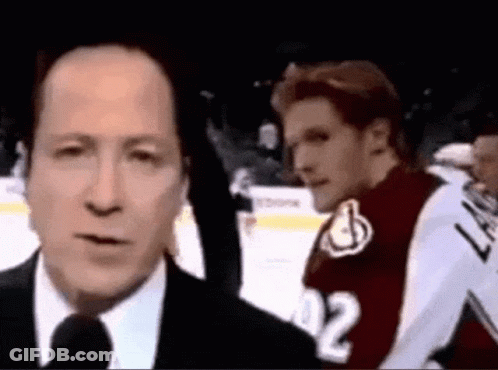 Man In Suit Talking Into Microphone GIF