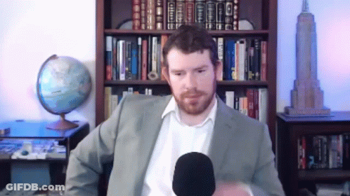 Man In Suit Talking Into Microphone GIF