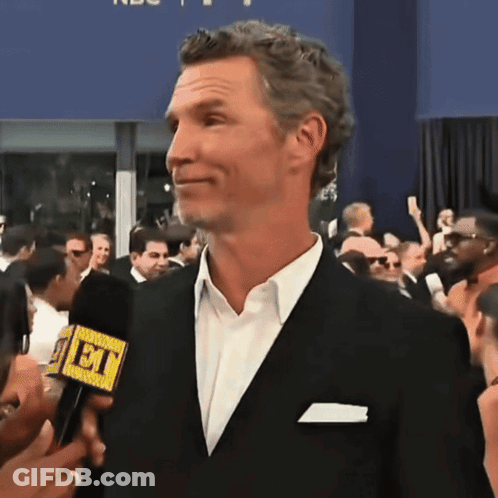 Man In Suit Talking Into Microphone Saying Et GIF