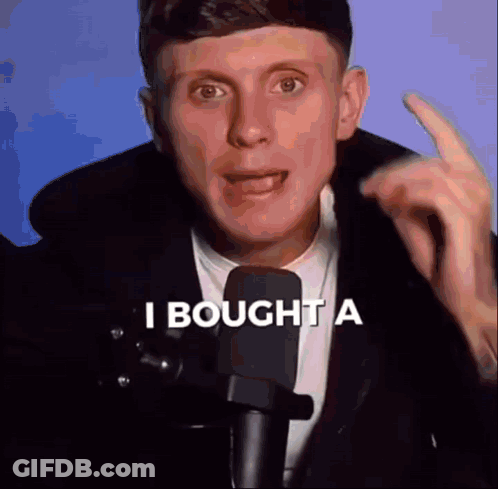 Man In Suit Talking Into Microphone Saying I Bought A GIF
