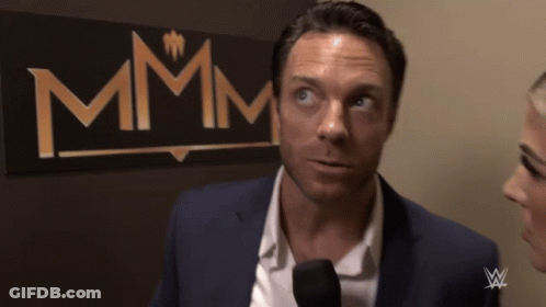Man In Suit Talking Into Microphone Sign Says Mmmm GIF