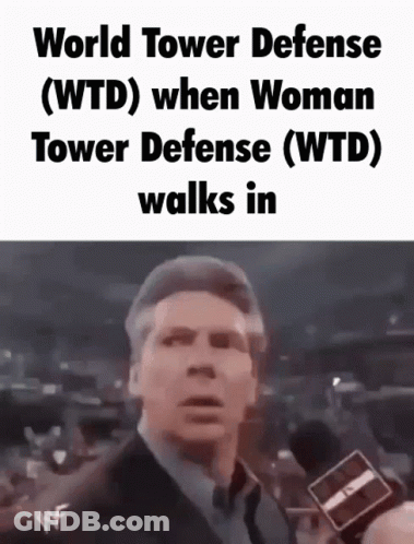 Man In Suit Talking Into Microphone Wearing World Tower Defense T-Shirt GIF