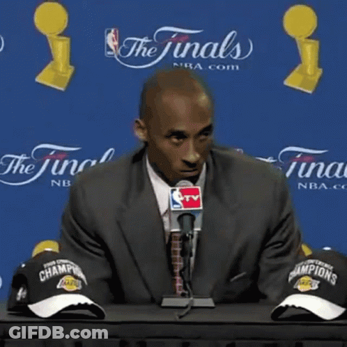 Man In Suit Talking Into Microphone What's There To Be Happy About GIF