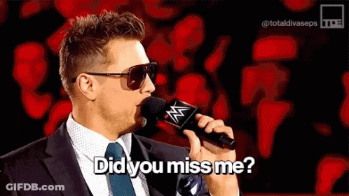 Man In Suit Talking Into Microphone With Sunglasses GIF