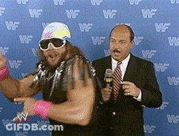 Man In Suit Talking Into Microphone GIF