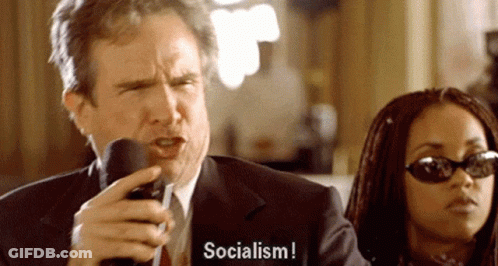 Man In Suit Talking Mic Woman Says Socialism GIF