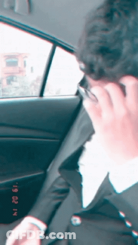 Man In Suit Talking On Cell Phone In Car February 22 GIF