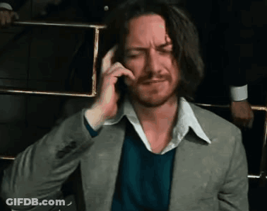Man In Suit Talking On Cell Phone While Sitting GIF