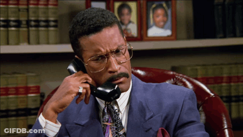 Man In Suit Talking On Phone GIF