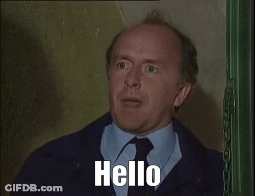 Man In Suit Talking On Phone Saying Hello GIF