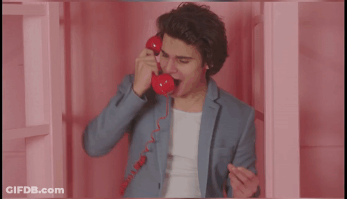 Man In Suit Talking On Red Telephone Saying More GIF