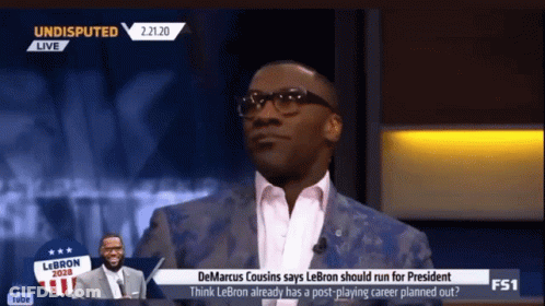 Man In Suit Talking On TV Show GIF