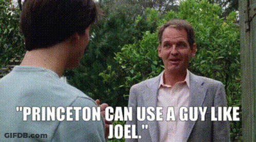 Man In Suit Talking To Another In Garden GIF