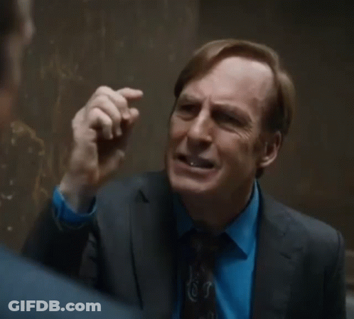 Man In Suit Talking To Another In Hallway GIF
