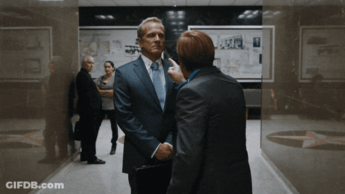 Man In Suit Talking To Another Man GIF