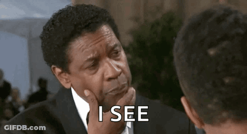 Man In Suit Talking To Another Man Hand On Chin GIF