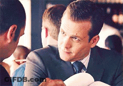 Man In Suit Talking To Another Man Holding Paper GIF