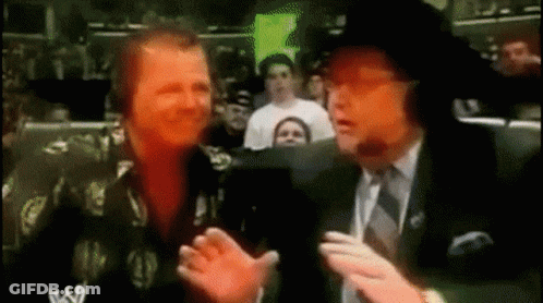 Man In Suit Talking To Another Man In Crowd GIF