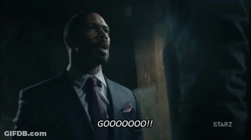 Man In Suit Talking To Another Man In Dark Room GIF