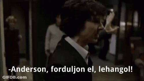 Man In Suit Talking To Another Man In Dark Room GIF